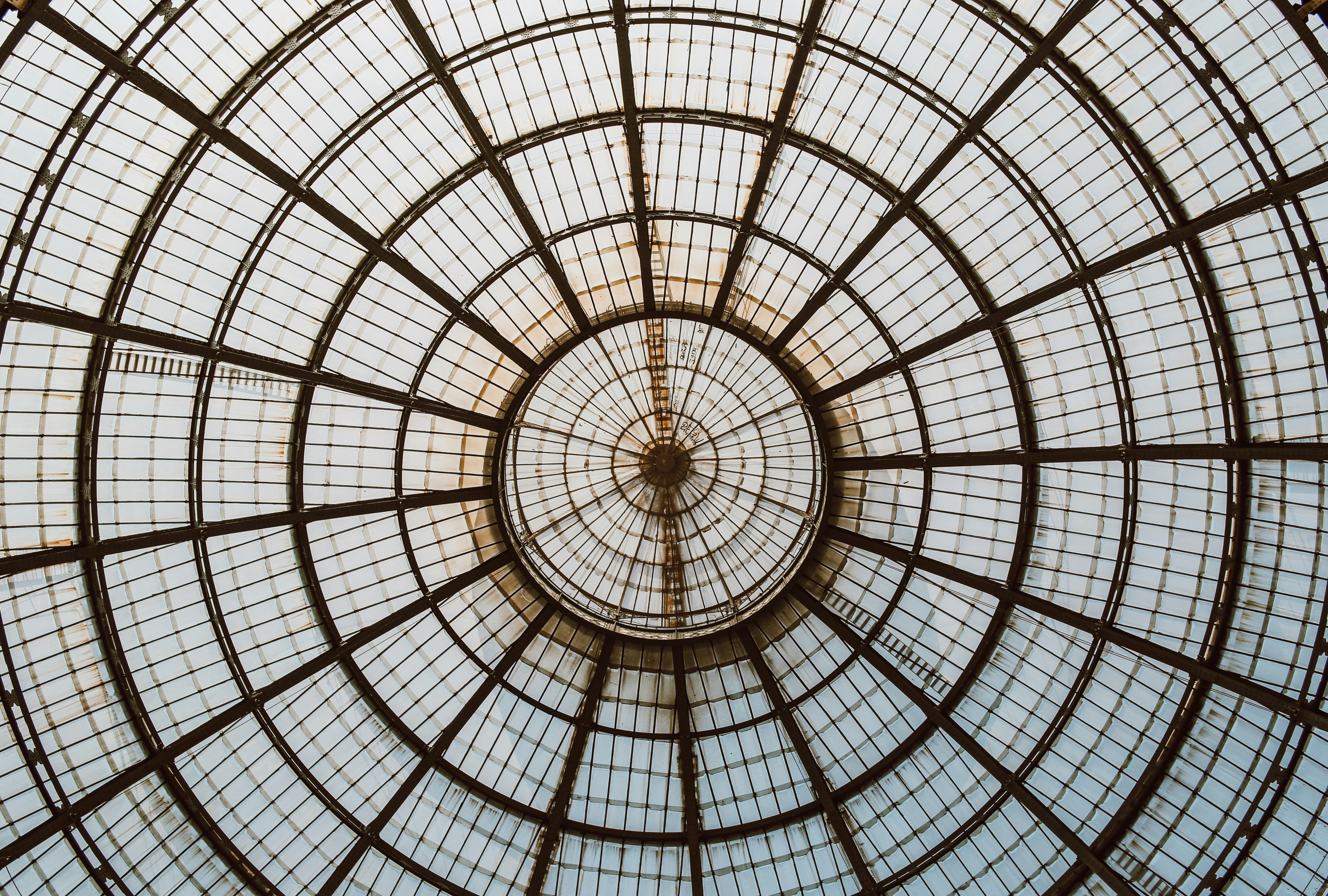 a view of the ceiling of a glass building